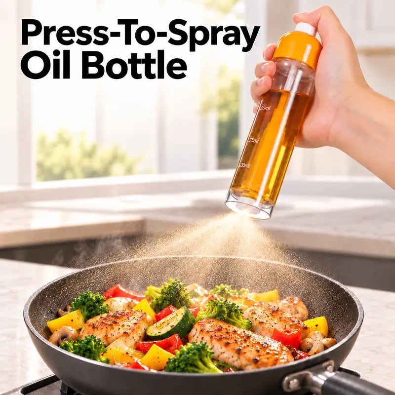 A refillable bottom-nozzle oil sprayer misting a pan of vegetables